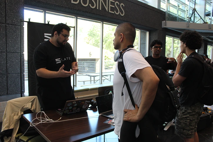 Showing Slate to a visitor at the Hack-a-Bull table